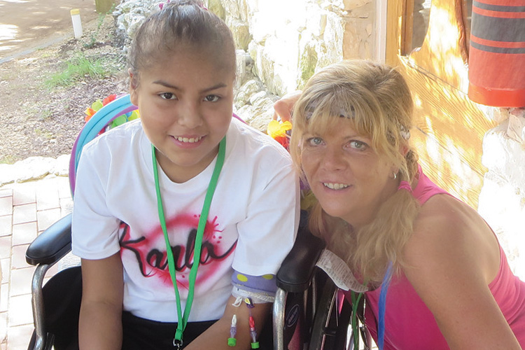 A woman and girl sitting next to each other.