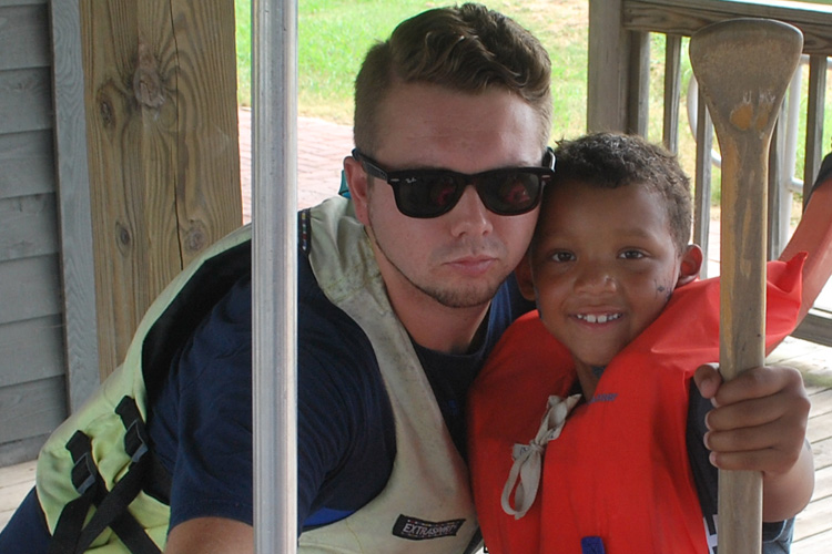 A man and boy are posing for the camera.