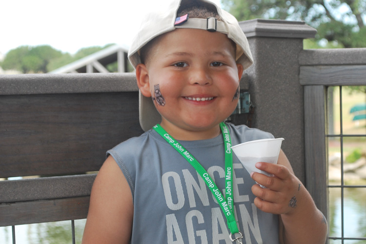 A young boy with a cup of coffee.