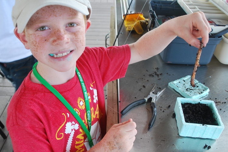 A boy is holding some tools in his hand.