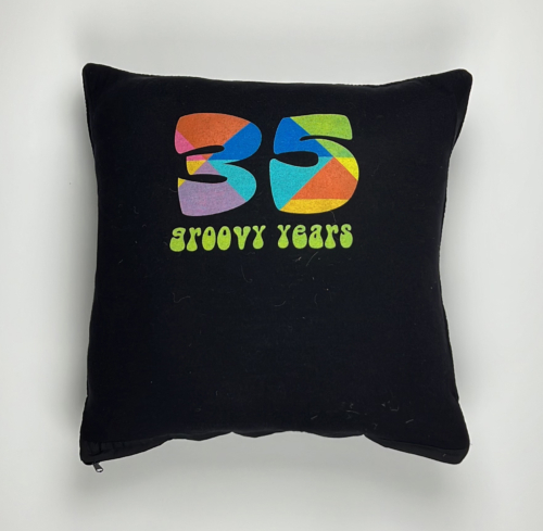 A black pillow with the number 3 5 and groovy years on it.