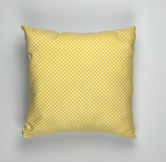 A yellow pillow with a pattern on it.